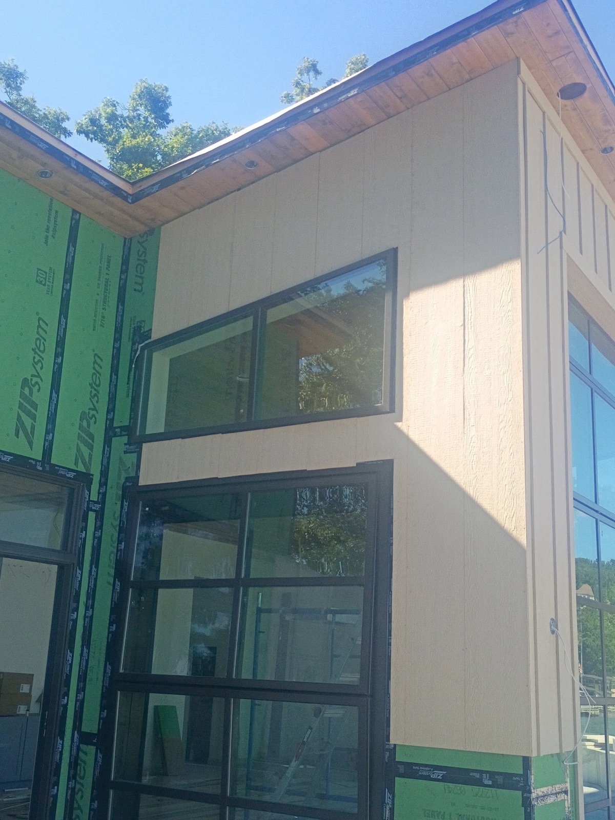 New black-frame windows and cedar soffit detail on an Ireland Construction custom build at the lake